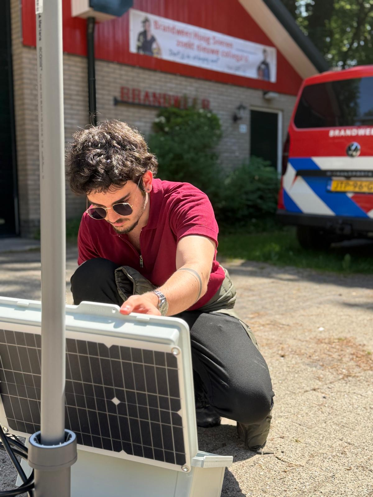 Res-Q Net engineer installing a solar-powered field communication unit outside a fire station